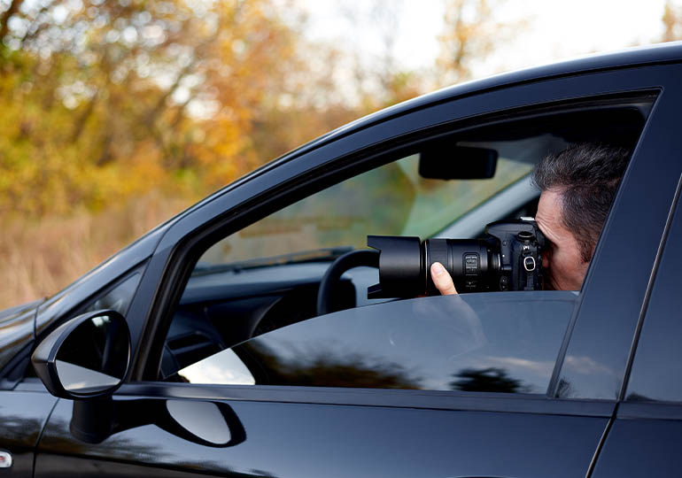Man photographing from inside of a car