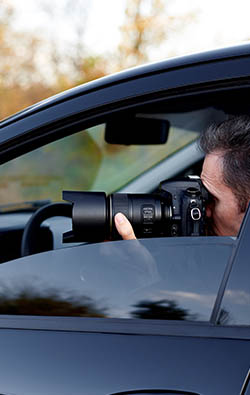 Man using a camera from the inside of a car