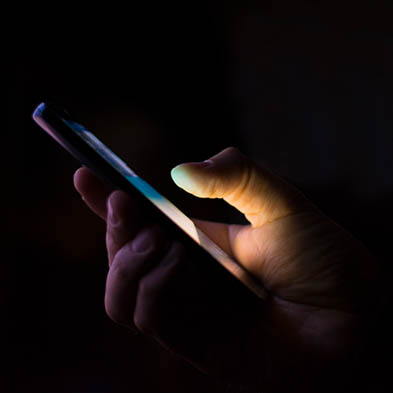 Holding a mobile phone in the dark