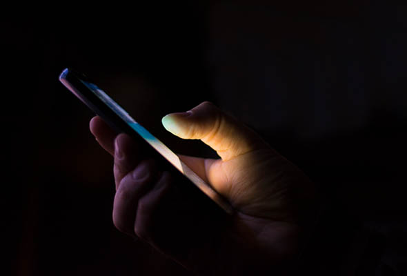 Holding a mobile phone in the dark